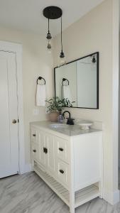 a white bathroom with a sink and a mirror at Sandy Pacific Hideaway 1 in Florence +48 photos