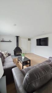 a living room with a couch and a fireplace at Sandy Pacific Hideaway 1 in Florence