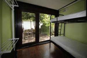a bedroom with a bunk bed and a balcony at Casa do Rio Fervença in Bragança +34 photos