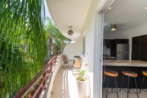 a balcony with a table and chairs and a kitchen at Margaritas Condos in Downtown of Playa in Playa del Carmen