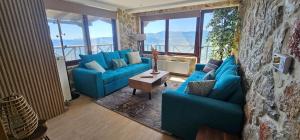 a living room with a blue couch and a table at Mont Rock in Synikia Mesi Trikalon