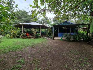two pavilions in a garden with a grass field at Marea Viajera - Hostal in Drake Bay Airport +12 photos
