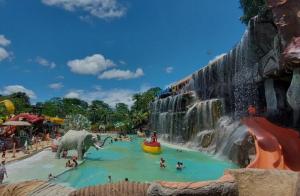 a waterfall at a water park with people in it at Alojamiento Sol Naciente in Puerto Triunfo