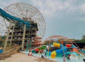 a water park with two slides and a roller coaster at Alojamiento Sol Naciente in Puerto Triunfo