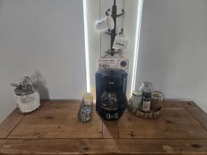a coffee maker sitting on top of a wooden table at Bigfoots Bungalow in Bandera +5 photos
