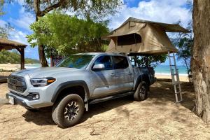 a silver truck with a tan tent in the back at Kauai Explorer Rooftop Camper Drive, Camp & Relax in Anahola