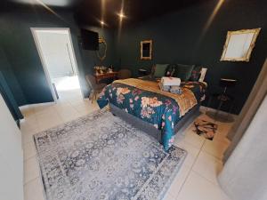 a bedroom with a bed and a rug at Dragonfly in Boksburg
