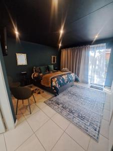 a bedroom with a bed and a window and a rug at Dragonfly in Boksburg