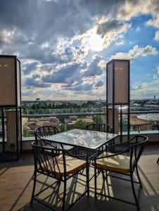 a table and chairs on a balcony with a view at Goldcrest Mall & Residency - Luxury 1bhk, 2bhk, 3bhk Apartments in DHA Lahore in Lahore
