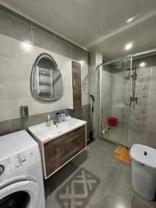 a bathroom with a sink and a washing machine at Yasmina apart in Bejaïa +12 photos