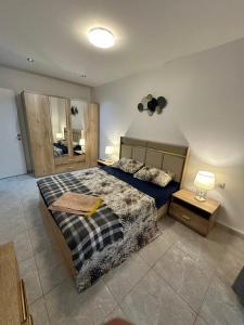 a bedroom with a king sized bed and a mirror at Yasmina apart in Bejaïa