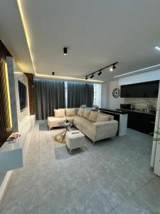 a living room with a couch and a kitchen at Yasmina apart in Bejaïa
