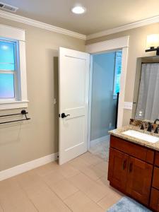 a bathroom with a sink and a mirror at The Mossy Nook A Cozy Escape in the Woods! in Issaquah