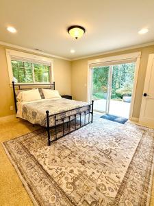 a bedroom with a bed and a large window at The Mossy Nook A Cozy Escape in the Woods! in Issaquah