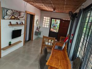 a living room with a table with a laptop on it at Mannah Garden Staycation House - Panglao, Bohol in Panglao Island