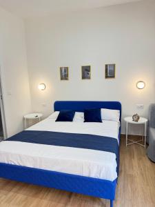 a blue and white bed in a room at Neapolitan Suites in Naples