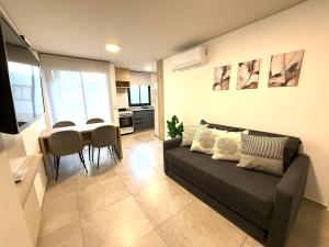 a living room with a couch and a table at Petit Premium Nueva Cba - Oulton in Córdoba