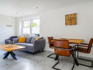 a living room with a couch and a table at Holiday apartment with 2 bedrooms in Greetsiel