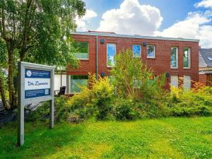 a brick building with a sign in front of it at Holiday apartment with 2 bedrooms in Greetsiel