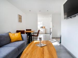 a living room with a couch and a wooden coffee table at Holiday apartment with 2 bedrooms in Greetsiel