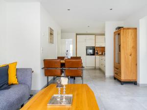 a living room with a couch and a table at Holiday apartment with 2 bedrooms in Greetsiel