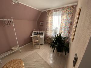 a room with a table and a window with a plant at Holiday home with 2 bedrooms in Neu Sankt Jürgen