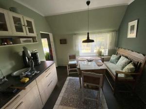 a kitchen and living room with a table and a couch at Holiday home with 2 bedrooms in Neu Sankt Jürgen +26 photos