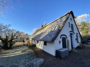 an old white building with a thatched roof at Holiday home with 2 bedrooms in Neu Sankt Jürgen