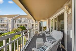 a balcony with chairs and tables on a house at Wildwood Crest SeaPointe Village Condo condo in Diamond Beach