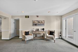 a living room with two chairs and a table at Wildwood Crest SeaPointe Village Condo condo in Diamond Beach