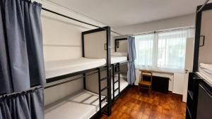 a room with two bunk beds and a window at Akarregi-Kanpaia albergue de peregrinos in Getaria