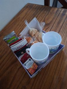 a table with two cups and some food on it at Santa Rita in Colón