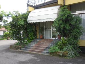 a building with stairs and an awning on it at Hotel Marchina in Brescia