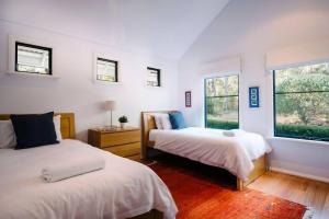 deux lits dans une chambre avec deux fenêtres dans l'établissement Idyll Estate - Bushland Gem with Spa & Tennis Court, à Yallingup Siding