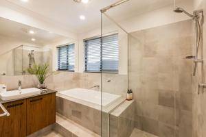 un bagno con doccia, vasca e lavandino di Front 9 - A Luxury Golf Lovers Getaway a Dunsborough Altre 45 foto