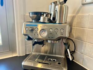 a coffee maker sitting on top of a kitchen counter at The WardRobe Pet Friendly Vintage Vibes at The Seaside in Robe +28 photos