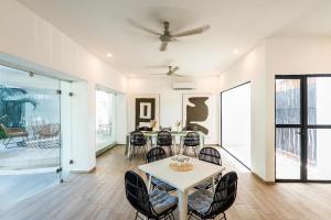 a dining room with a table and chairs at La Veleta Hotel - Pool Access Room in Tulum
