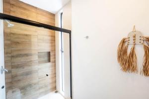 a bathroom with a shower and a glass door at La Veleta Hotel - Tulum Vibes - Pool View in Tulum
