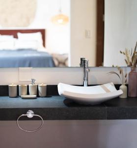 a bathroom with a sink and two candles on a counter at La Veleta Hotel - Tulum Vibes - Pool View in Tulum +30 photos