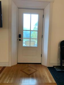 a room with a door with a window and a wooden floor at Riverbend Berkshire East Basecamp in Charlemont