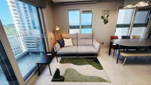 a living room with a couch and a table at Busan Osiria Residence Losiria in Busan +48 photos
