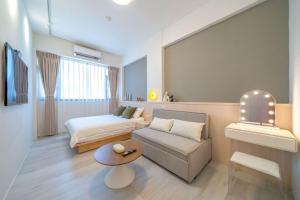 a living room with a bed and a couch at 海燕民宿 in Suao
