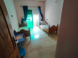 a living room with two beds and a window at Célia House in Fès +1 photo
