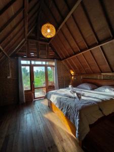a bedroom with a bed with a bird laying on it at 361 Terrace Bungalows in Rarang
