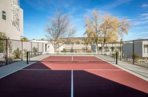 a tennis court in front of a building at Spacious 5BR Resort Waterpark Access Sleeps 16 in Saint George Municipal Airport +38 photos