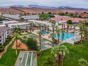an aerial view of a resort with a pool and palm trees at Spacious 5BR Resort Waterpark Access Sleeps 16 in Saint George Municipal Airport