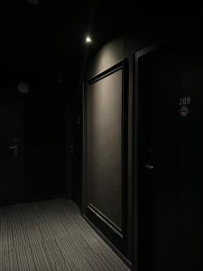 an empty hallway with a door in the dark at Hotel Monopol City Centre in Düsseldorf