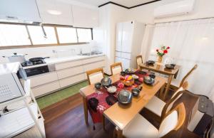 a kitchen and dining room with a table and chairs at Chikuan Kyoto Whole Rental Lodging - Vacation STAY 78789v in Kyoto +10 photos