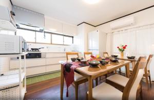 a kitchen with a wooden table and chairs in a room at Chikuan Kyoto Whole Rental Lodging - Vacation STAY 78789v in Kyoto