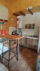 a kitchen with a table and chairs in a room at Entre Cerros Tiny House Única in Moquehue